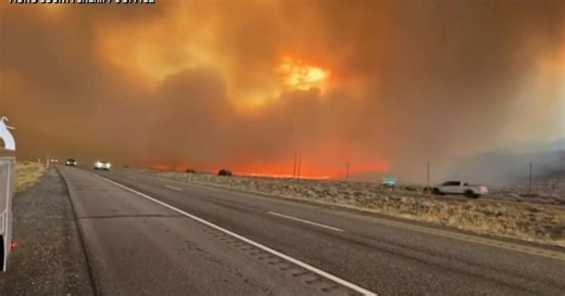 California wildfire explodes as storm threatens mudslides in southern part of state