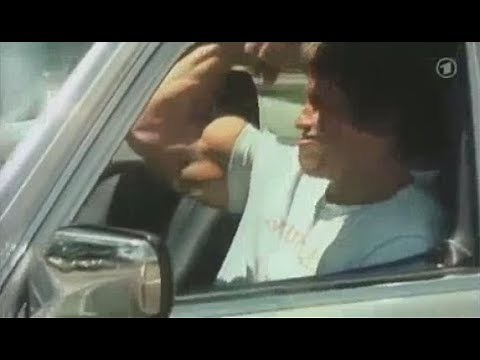Arnold Schwarzenegger - Flexing Biceps In The Car
